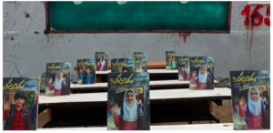 RNTimage from Amnesty International REVOLUTIONARY News TODAY - Revolutionary News Today! Rows of School Posters Showing a Smiling Girl in a Blue Hijab Raising Her Hand on Desks, Urdu Text Visible, Chalkboard in the Background.