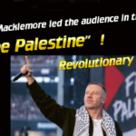 - Revolutionary News Today! Rapper Macklemore on Stage Raising a Microphone at a Rally, with a 'free Palestine' Sign Visible in the Background.